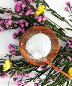The content of a pouch of Nicole's Natural Lavender Calming Face Mask, in a wooden bowl