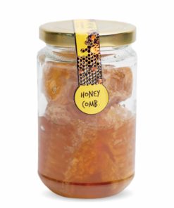A jar containing raw red honey and honeycomb