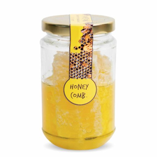 A jar of raw white honey and comb