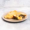 A plate containing 2 homemade Bali Buda mini calzones