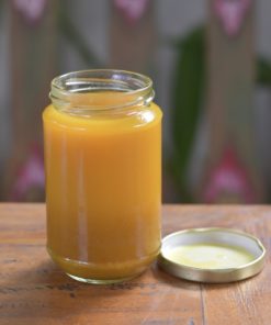 A glass jar containing Bali Buda homemade extreme jamu, a concentrate turmeric juice offering many benefits for your health.