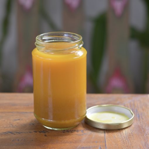 A glass jar containing Bali Buda homemade extreme jamu, a concentrate turmeric juice offering many benefits for your health.