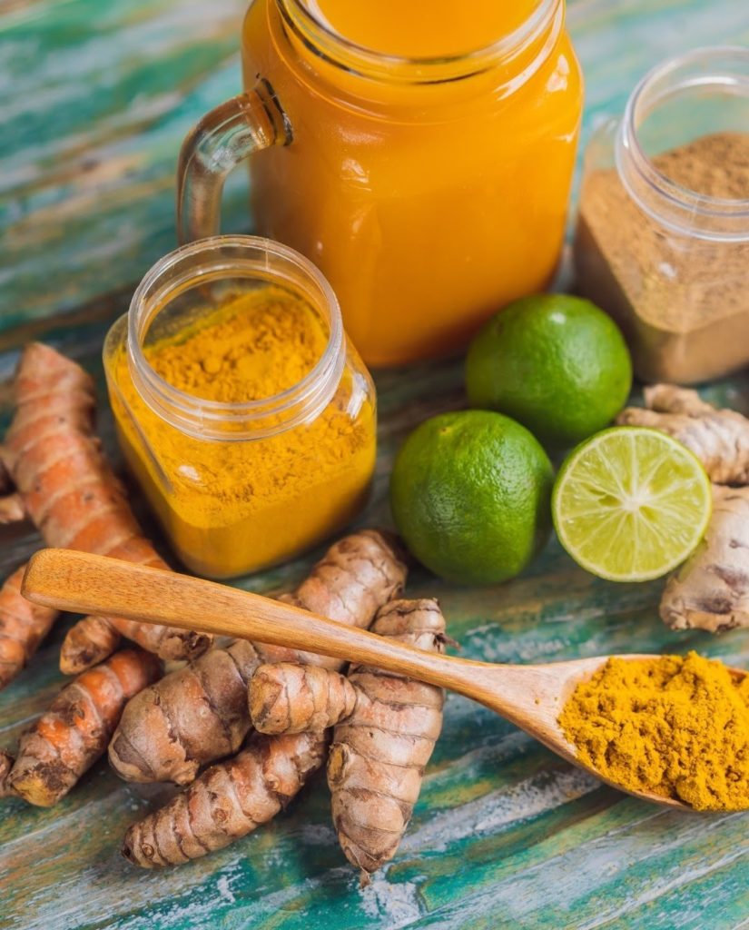 Turmeric root, turmeric powder and limes for making jamu, a turmeric juice with plenty of benefits