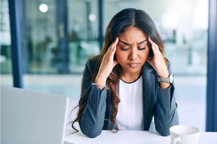 a woman showing signs of high stress, at work